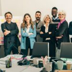 Unternehmerteam steht gemeinsam im Büro und plant neue Projekte | Anwaltskanzlei IT Recht